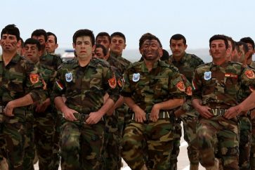 Iraqi Christian forces march during their graduation ceremony in the northwestern town of Fishkhabur, near the borders with Syria and Turkey, on March 12, 2015. The 600-strong regiment, which graduated after a six-week training, will answer to the government of the autonomous Kurdish region and was formed to contribute to the recapture of the Nineveh Plain, a region between the Islamic State (IS) group hub of Mosul and the Kurdish capital Arbil which was home to most of Iraqs Christian minority until IS jihadists swept in seven months ago. AFP PHOTO / SAFIN HAMED        (Photo credit should read SAFIN HAMED/AFP/Getty Images)