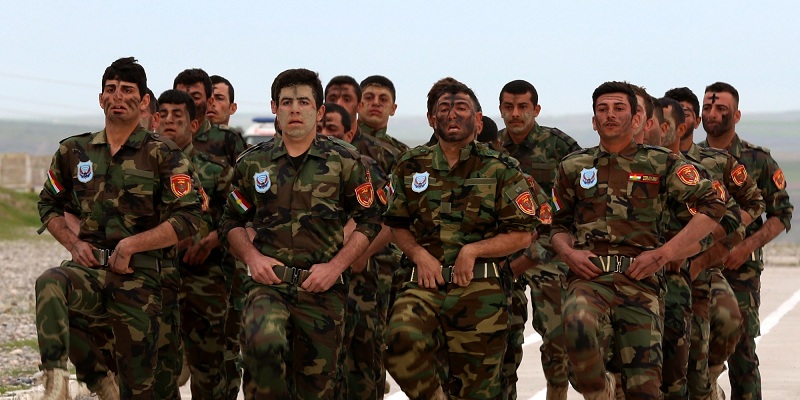 Iraqi Christian forces march during their graduation ceremony in the northwestern town of Fishkhabur, near the borders with Syria and Turkey, on March 12, 2015. The 600-strong regiment, which graduated after a six-week training, will answer to the government of the autonomous Kurdish region and was formed to contribute to the recapture of the Nineveh Plain, a region between the Islamic State (IS) group hub of Mosul and the Kurdish capital Arbil which was home to most of Iraqs Christian minority until IS jihadists swept in seven months ago. AFP PHOTO / SAFIN HAMED        (Photo credit should read SAFIN HAMED/AFP/Getty Images)