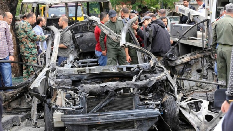 Syrians surround a the wreckage of a car following an explosion in Damascus on May 9, 2018.
A shelling and a car bomb blast in Syria's capital Damascus killed two people and wounded several others today, state television said. It reported "two killed and 14 wounded in terrorist attacks on Damascus Tower and Maysat Square". The shell struck at the tower in the central Marjeh Square district while the car bomb went off in the northeast of the city.
/ AFP PHOTO / LOUAI BESHARA