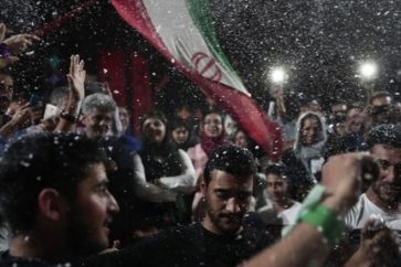 Supporters of newly re-elected Iranian President Hassan Rouhani dance during a gathering to celebrate his victory at the Vanak square in downtown Tehran on May 20, 2017.
Iran has chosen the "path of engagement with the world" and rejected extremism, President Hassan Rouhani said following his resounding re-election victory. / AFP PHOTO / Behrouz MEHRI