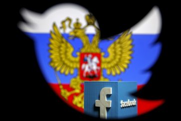 A Russian flag and a 3D model of the Facebook logo is seen through a cutout of the Twitter logo in this photo illustration taken in Zenica, Bosnia and Herzegovina,  May 22, 2015. Russia's media watchdog has written to Google, Twitter and Facebook warning them against violating Russian Internet laws and a spokesman said on Thursday they risk being blocked if they do not comply with the rules. Roskomnadzor said it had sent letters this week to the three U.S.-based Internet firms asking them to comply with Internet laws which critics of President Vladimir Putin have decried as censorship. REUTERS/Dado Ruvic      TPX IMAGES OF THE DAY      - GF10000104110