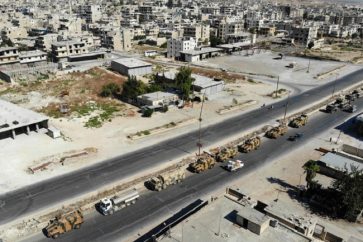 A picture taken on August 19, 2019 shows an aerial view of a convoy of Turkish military vehicles passing through Maaret al-Numan in Syria's northern province of Idlib reportedly heading toward the town of Khan Sheikhun in the southern countryside of the province. - Damascus today condemned the deployment of a Turkish military convoy towards a key town in northwestern Syria where regime forces are waging fierce battles with jihadists and rebels. (Photo by Omar HAJ KADOUR / AFP)