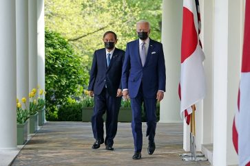 US President Joe Biden and Japan's Prime Minister Yoshihide Suga walk through the Colonnade to take part in a joint press conference in the Rose Garden of the White House in Washington, DC on April 16, 2021. (Photo by MANDEL NGAN / AFP)
