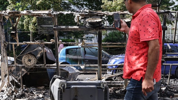 ©Mohammed Badra/EPA/MAXPPP - epa10715173 A man takes photos of burnt out cars and debris on avenue Pablo Picasso following a night of civil unrest, in Nanterre, near Paris, France, 28 June 2023. The violence broke out after police fatally shot a 17-year-old during a traffic stop in Nanterre. According to the French interior minister, 31 people were arrested with 2,000 officers being deployed to prevent further violence. EPA-EFE/Mohammed Badra (MaxPPP TagID: maxbestof266454.jpg) [Photo via MaxPPP]