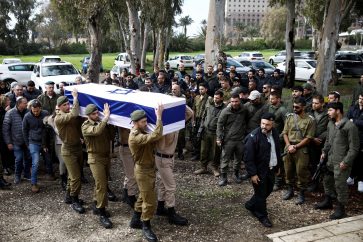 Israeli soldiers carry the casket of Israeli military reservist Sergeant Major Matan Lazar, 32, who was killed in the southern Gaza Strip amid the ongoing ground operation of the Israeli army against Palestinian Islamist group Hamas, at his funeral, in Haifa, Israel, January 23, 2024. REUTERS/Shir Torem